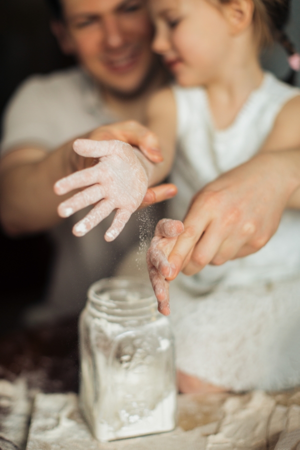 Girl clapping hands with flour