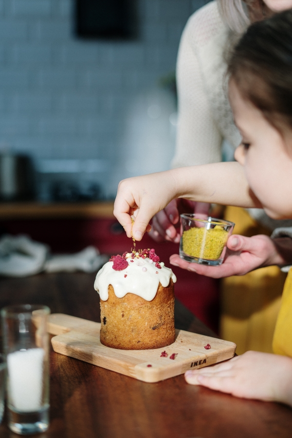 Teacher and student decorating cake