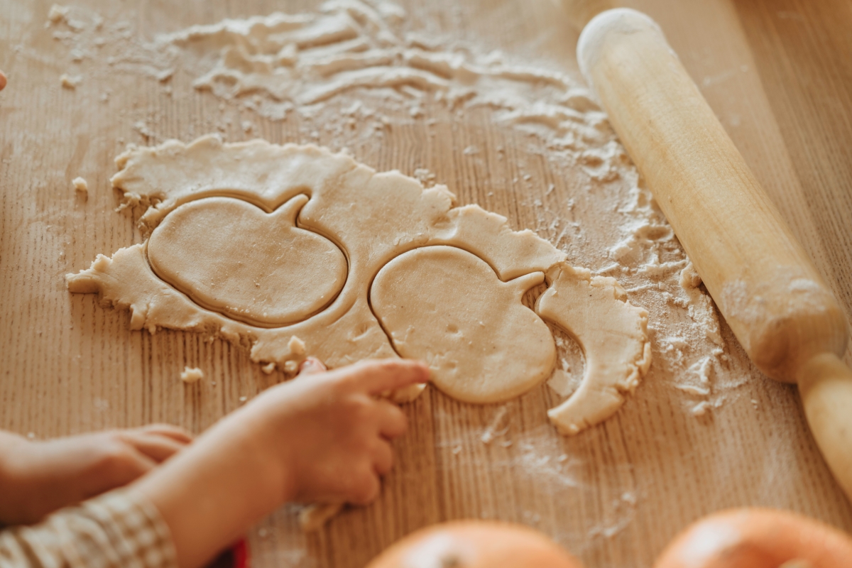 Pumpkin shaped cookies cut out in dough